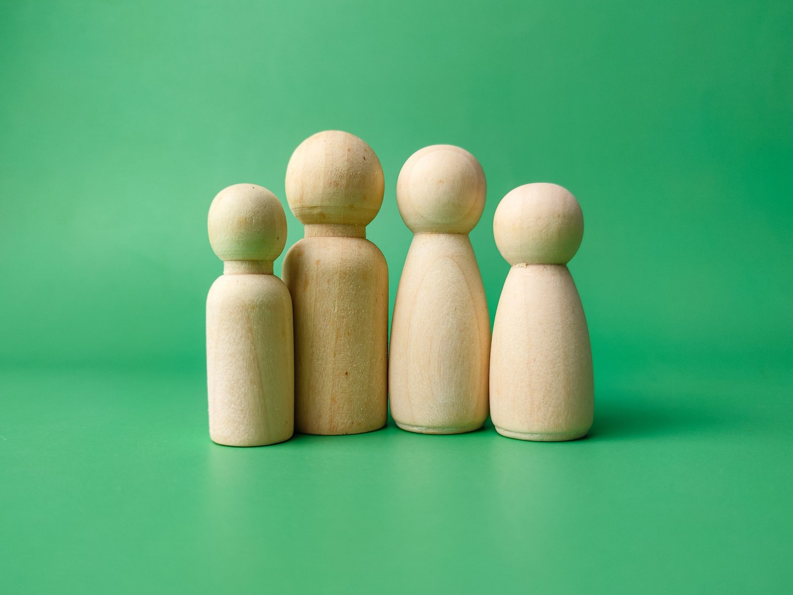 A wooden peg doll family. The family concept